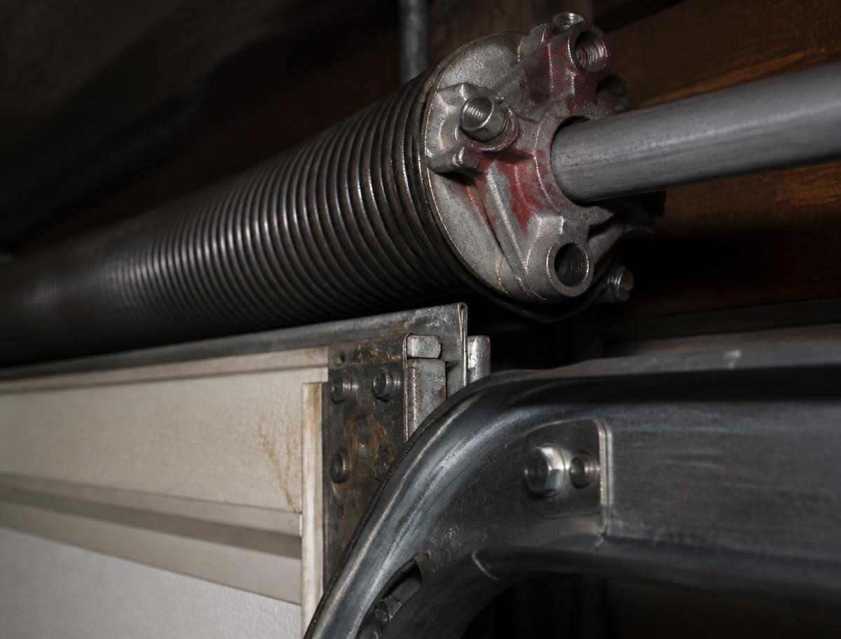 Torsion spring and steel track assembly on a residential garage door